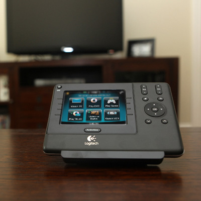 LOGITECH® Harmony 1100 Universal Remote with Color Touch Screen - Let the show begin with this Universal Remote! It features customizable color command screens and seamless control of up to 15 home theater components. This 3.5” color touch-screen tablet lets you launch your movies, music, games, videos and favorite stations with a single touch. Controls are easy to access and backlit.