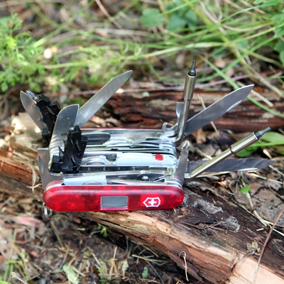 VICTORINOX® Swiss Champ® XAVT - This beautiful knife with red translucent handles provides 80 essential functions all packed into one tool.  Too many options to list, but includes large blade, small blade, electrician's blade, scissors, pruning blade, barometer, alarm, thermometer, corkscrew, mini screwdriver, ball point pen, toothpick, tweezers and key ring, just to name a few.  Comes packed in attractive gift box.